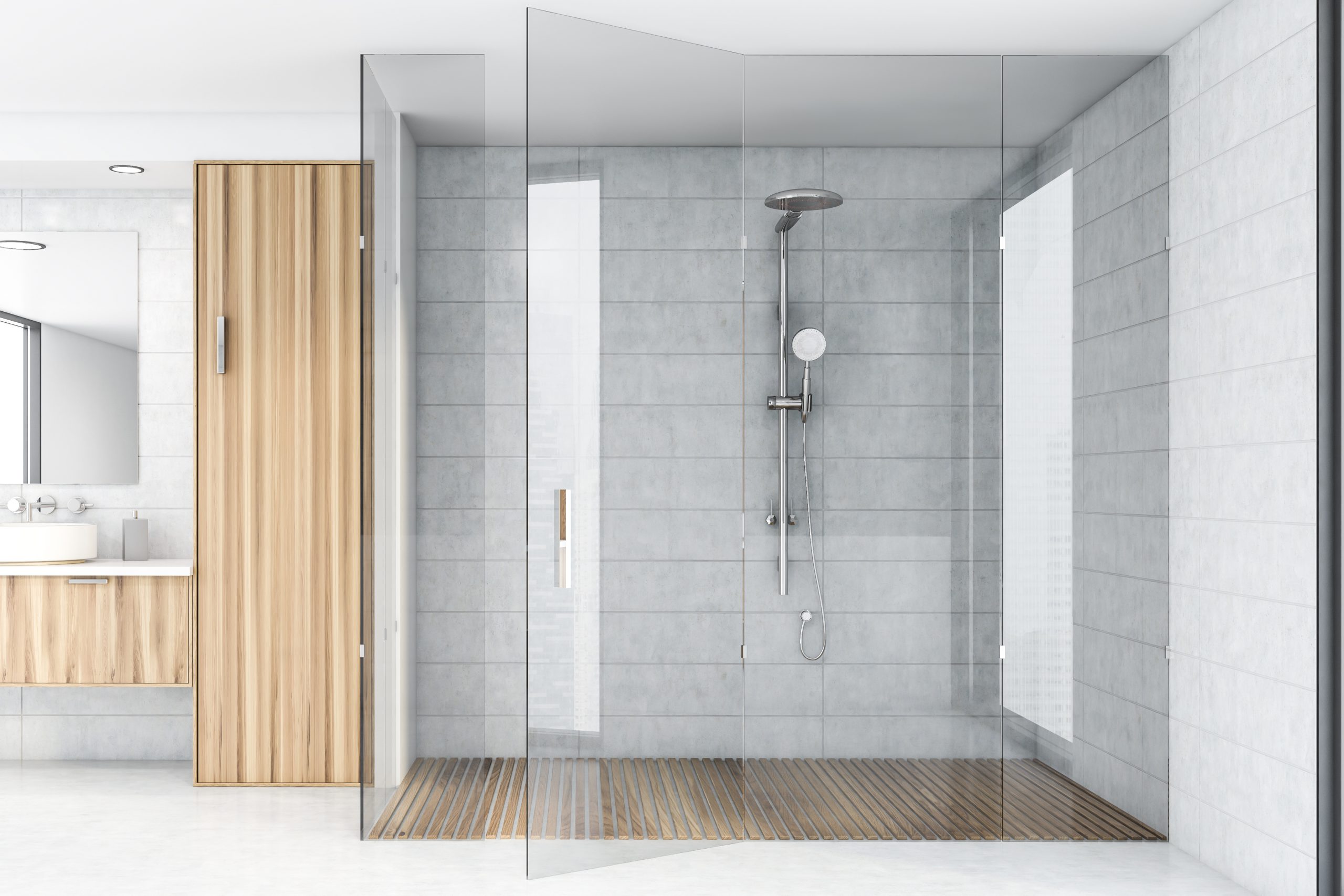 Grey tiles in combination with wooden tiles in a large bathroom equipped with walk-in glass shower doors